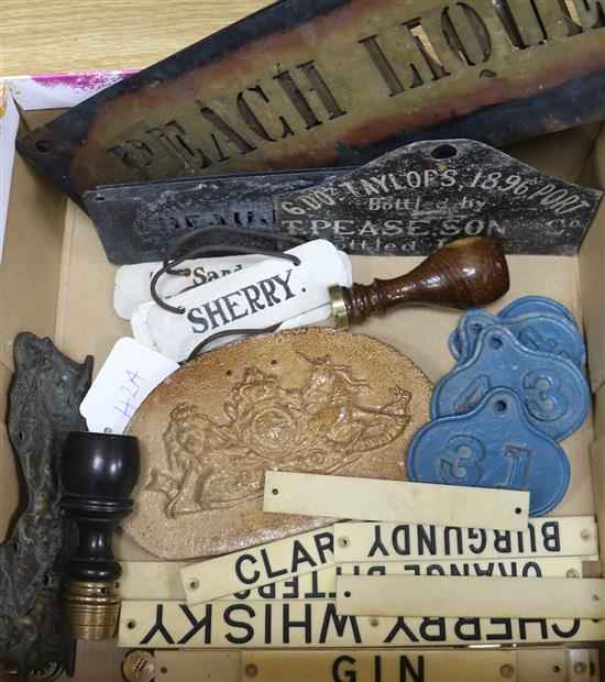 A collection of assorted cellar labels including ivorine and metal, five pierced metal stencils, a cast bronze plaque 17cm